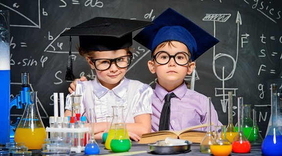 Zwei Kinder vor Tafel im Chemielabor